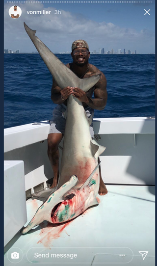 Illustration for article titled Von Miller Says The Bloody Shark He's Holding Didn't Die